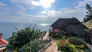 A stone building with a sign reading "Welcome to Haxuna Malaba." - Hakuna Matata Lodge (Gisenyi)