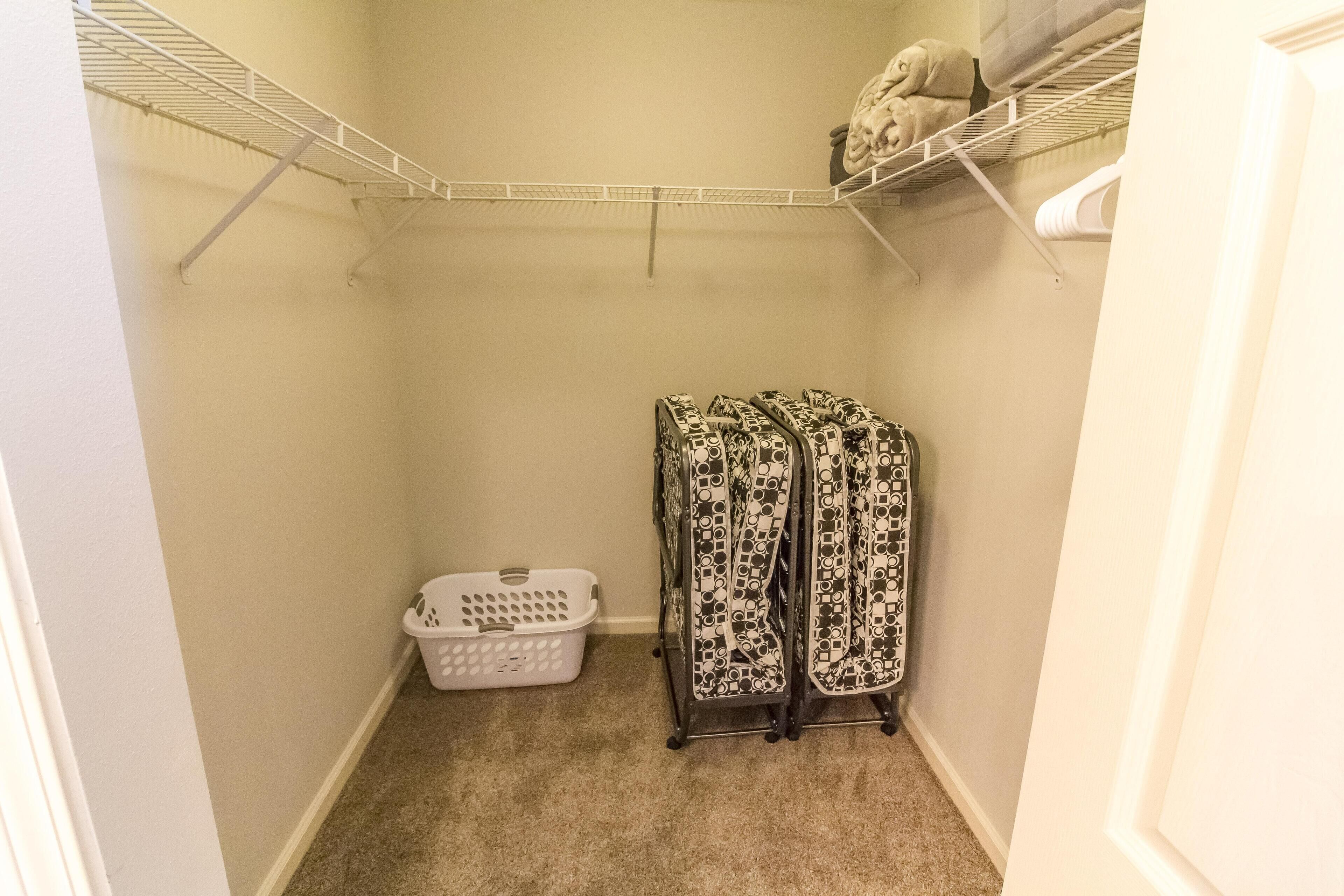 A laundry room with a washing machine, a dryer, and a laundry basket.