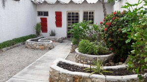 Stroll through the beautifully landscaped gardens to the charming entrance of this serene retreat.