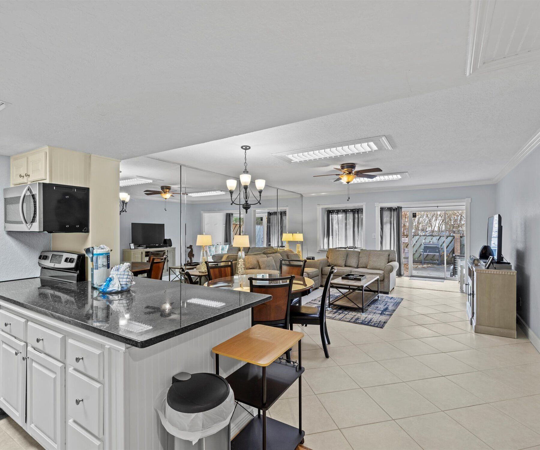 A spacious living area with a kitchen, dining table, and seating.