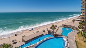 A resort with a beach, a pool area, and a view of the ocean. - Sonoran Sky 703 "H20-365" Great Oceanfront (Puerto Peñasco)