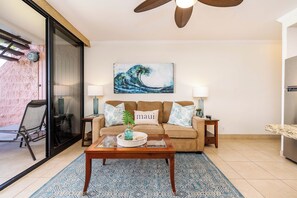 A living room with a sofa, coffee table, and artwork. - Now Booking! Oceanfront Best View Kuleana 614 AC Pool Lanai (Lahaina)