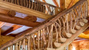 A wooden staircase with a unique design featuring logs as steps and railings. - 7 Bedroom 5.5 Bath Stunning Luxury Log, Reunions & Weddings Welcomed (Maggie Valley)