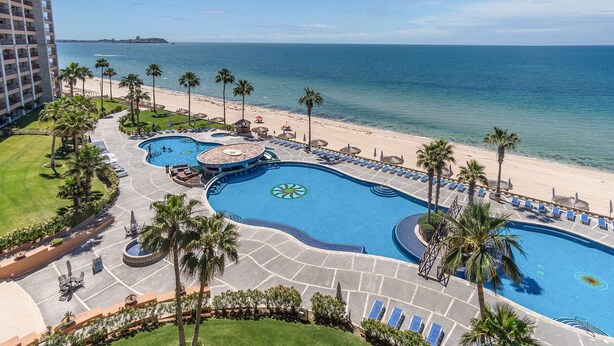 A resort with multiple swimming pools, a beach, and a view of the ocean. - *Premier Host* Sonoran Sun W-609  Sun & Fun Sanctuary Spacious Oceanfront (Puerto Penasco)