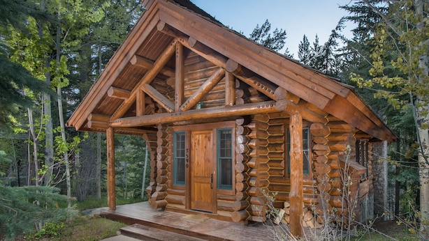 A log cabin with a wooden porch, a front door, and a window. - JHRL - Beautiful Single-Family Granite Ridge Cabin #7590, Hot Tub (Teton Village)