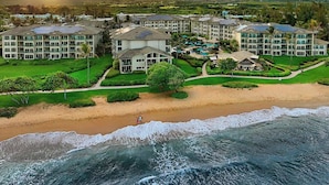 A beachfront hotel with multiple buildings, a pool area, and a beach. - F302 - Amazing Location! Modern, Clean Furnishings - Sleeps 6 in AC Comfort! (Kapaa)