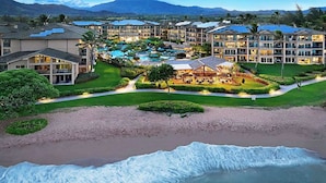 A resort with multiple buildings, a swimming pool, and a beach. - F302 - Amazing Location! Modern, Clean Furnishings - Sleeps 6 in AC Comfort! (Kapaa)
