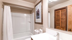 A bathroom with a shower, toilet, sink, and a framed picture of a bear. - JHRL - Teewinot D4, Great Slopeside Location (Teton Village)