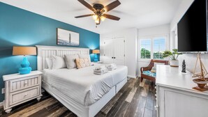 A bedroom with a bed, nightstands, a ceiling fan, a window, and a view of the outdoors. - 121- Ground floor unit-steps to the wonderful beach, W/D in unit,FREE Bch Svc (Destin)