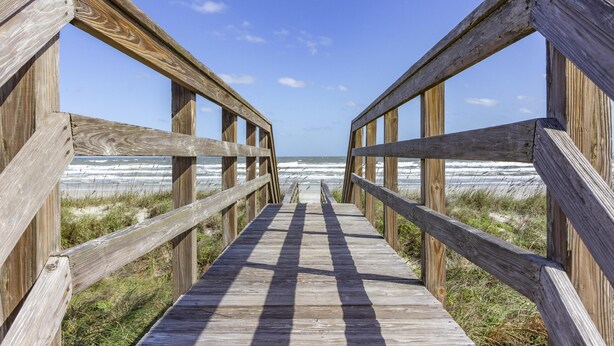 A wooden boardwalk leading to the beach with a clear view of the ocean. - Ocean View Pool Home ~ Heated Pool ~ Steps to the Beach! (Saint Augustine)