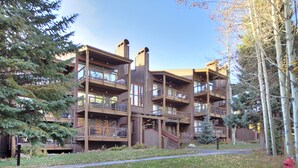 A multi-story building with balconies, a central staircase, and a sign that reads "LODGEPOL".