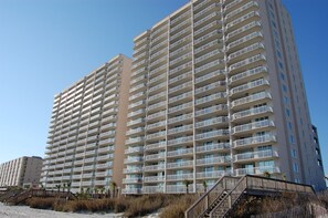 A high-rise hotel with multiple balconies and a beachside location. - Luxury oceanfront condo - Indoor/Outdoor Pools + Free Attraction Tickets! (North Myrtle Beach)