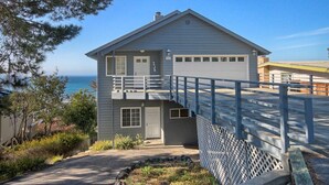 A two-story house with a garage, a balcony, and a view of the ocean. - Heavenly Ocean View - #LH37: 2  BR, 2  BA House in Cambria, Sleeps 4 (Cambria)