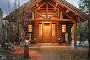A log cabin with a wooden front door, two windows, and a porch. - Abode on Obsidian, best value in Teton Village (Teton Village)