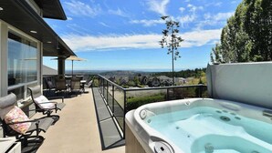 A balcony with outdoor seating, a hot tub, and a scenic view. - Nature's Gate Executive Estate (Victoria)