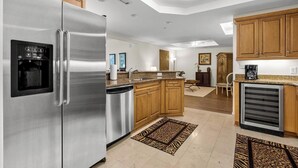 A modern kitchen with stainless steel appliances, wooden cabinets, and a built-in dishwasher. - $150 activities - E-gift card when you book - Extra Deep Oceanfront Balcony | M1606 (Myrtle Beach)
