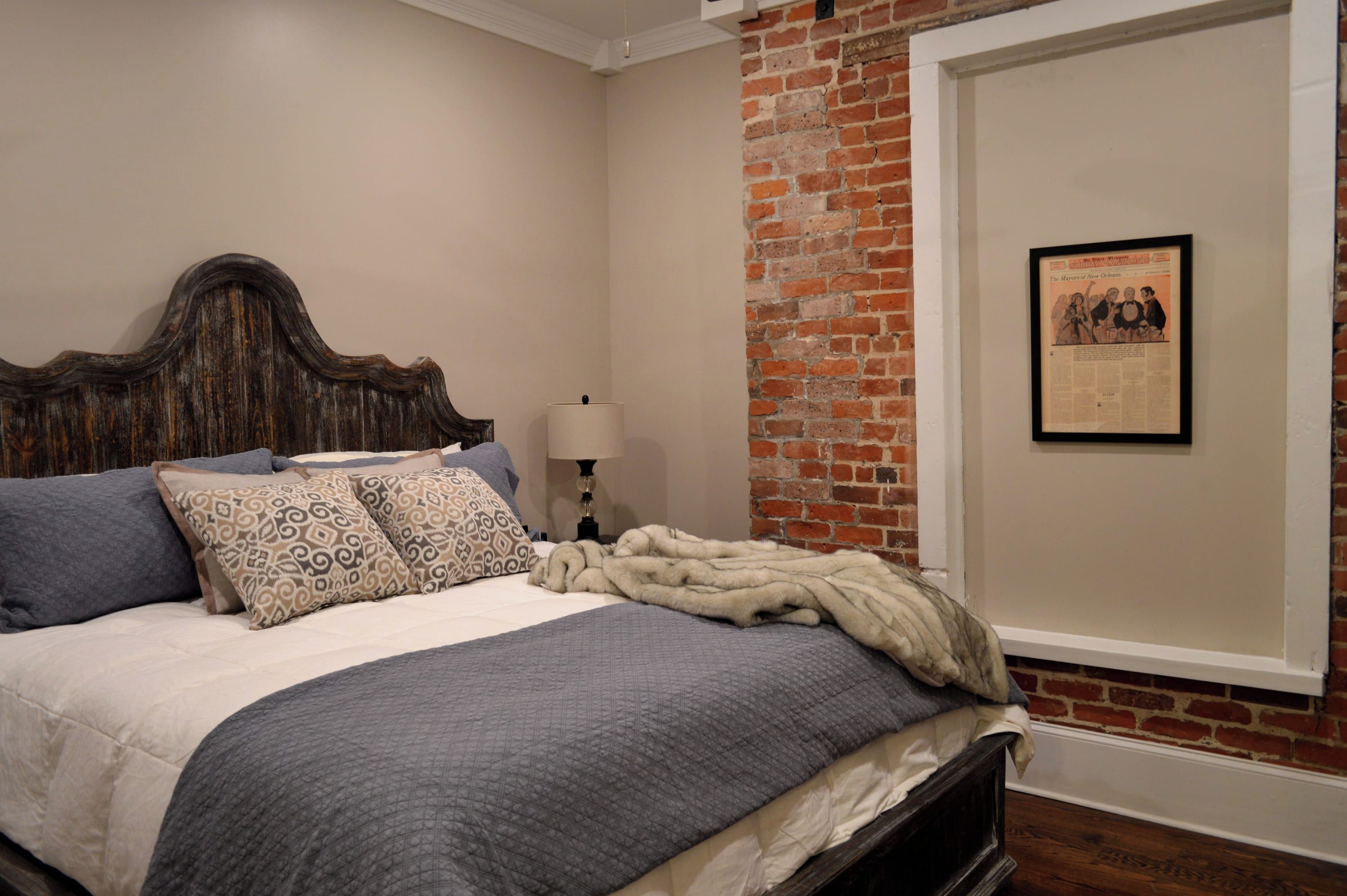 Main level King Bedroom has framed newspaper from the Times - Picayune, original occupant of this historic building built in the early 1880's
