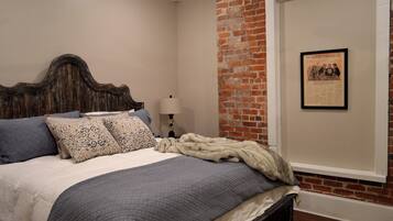 Main level King Bedroom has framed newspaper from the Times - Picayune, original occupant of this historic building built in the early 1880's
