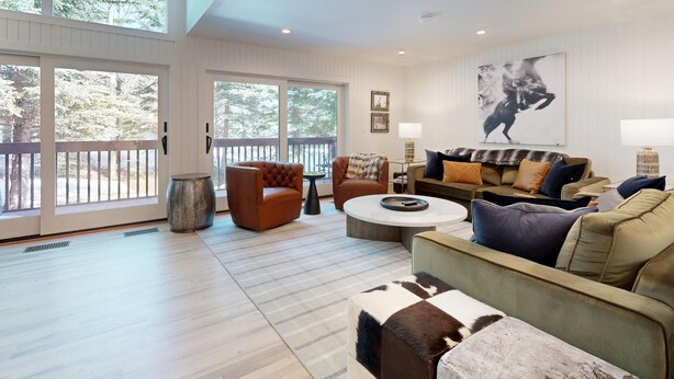 A spacious living room with a large window, a fireplace, and a cozy seating area. - JHRL - Wind River #2, Well-Appointed and Well-Located - 1 minute from Ski Access (Teton Village)