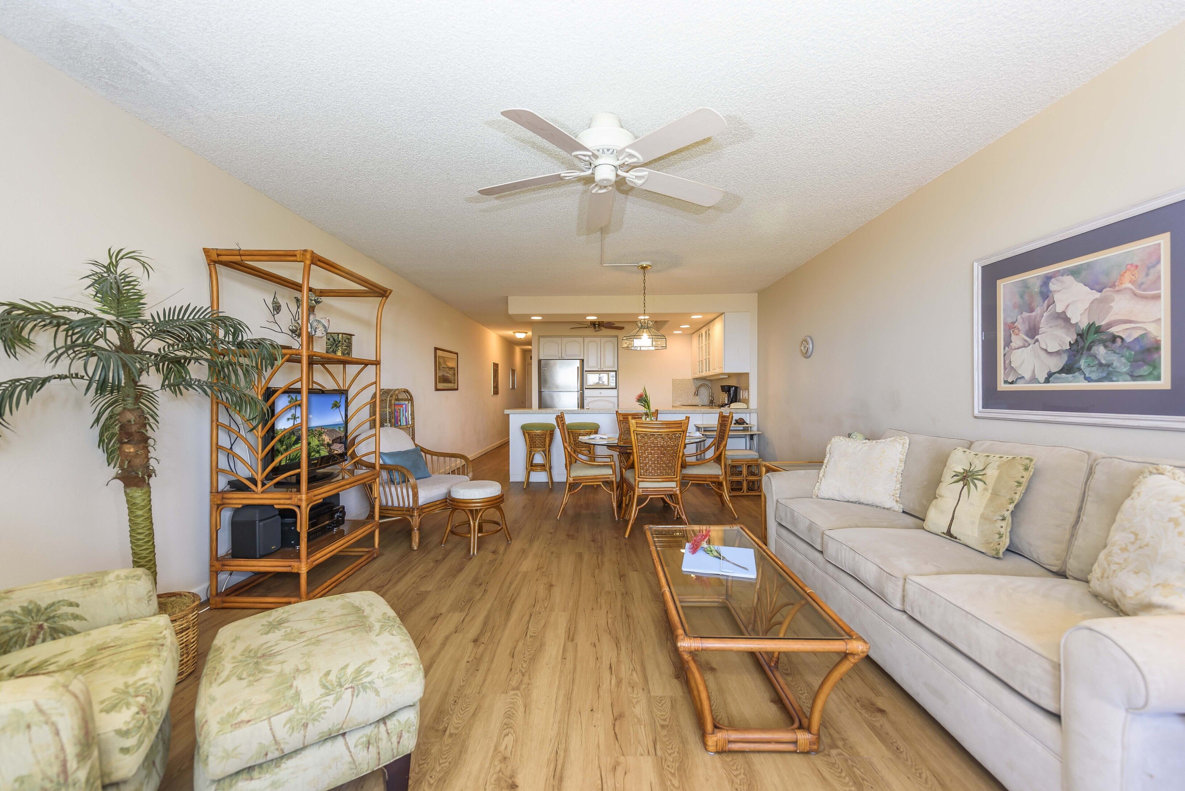 A spacious living room with a sofa, a coffee table, and a dining area with chairs and a table.