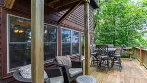A wooden deck with outdoor furniture, including chairs and a table, and large windows. - A Peak of Heaven 1 mi from Blue Ridge Parkway very private ping pong table (Boone)