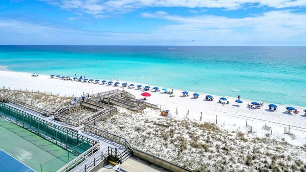 A beach with a clear sky, a sandy shore, and a pool area. - 603- Gulf Front with the Best Sunrise View, Plus FREE Beach Service (Destin)