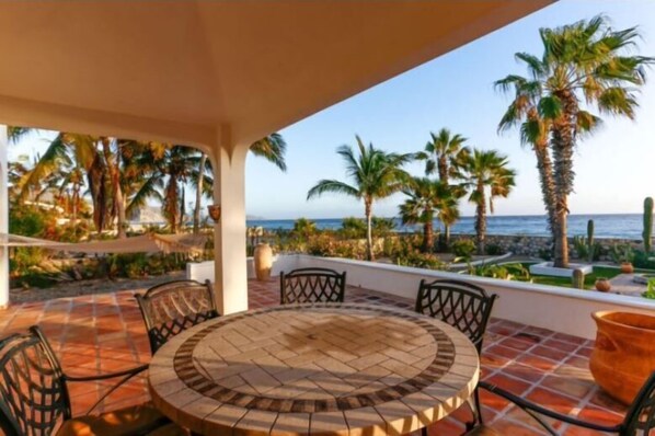 Relax in a tranquil outdoor space with ocean views and palm trees.