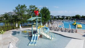 A water park with a pool, slides, and play structures.