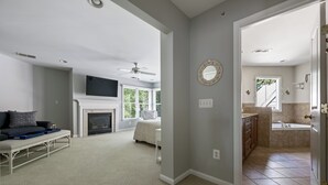 A spacious living room with a fireplace, a sofa, and a television.