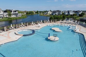 A swimming pool with a basketball court, lounge chairs, and a view of a river. - 22096 S Preservation Drive (Millsboro)