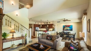A spacious living area with a staircase, a dining area, and a kitchen. - 3 Bedroom Ocean View Townhome (Waikoloa)