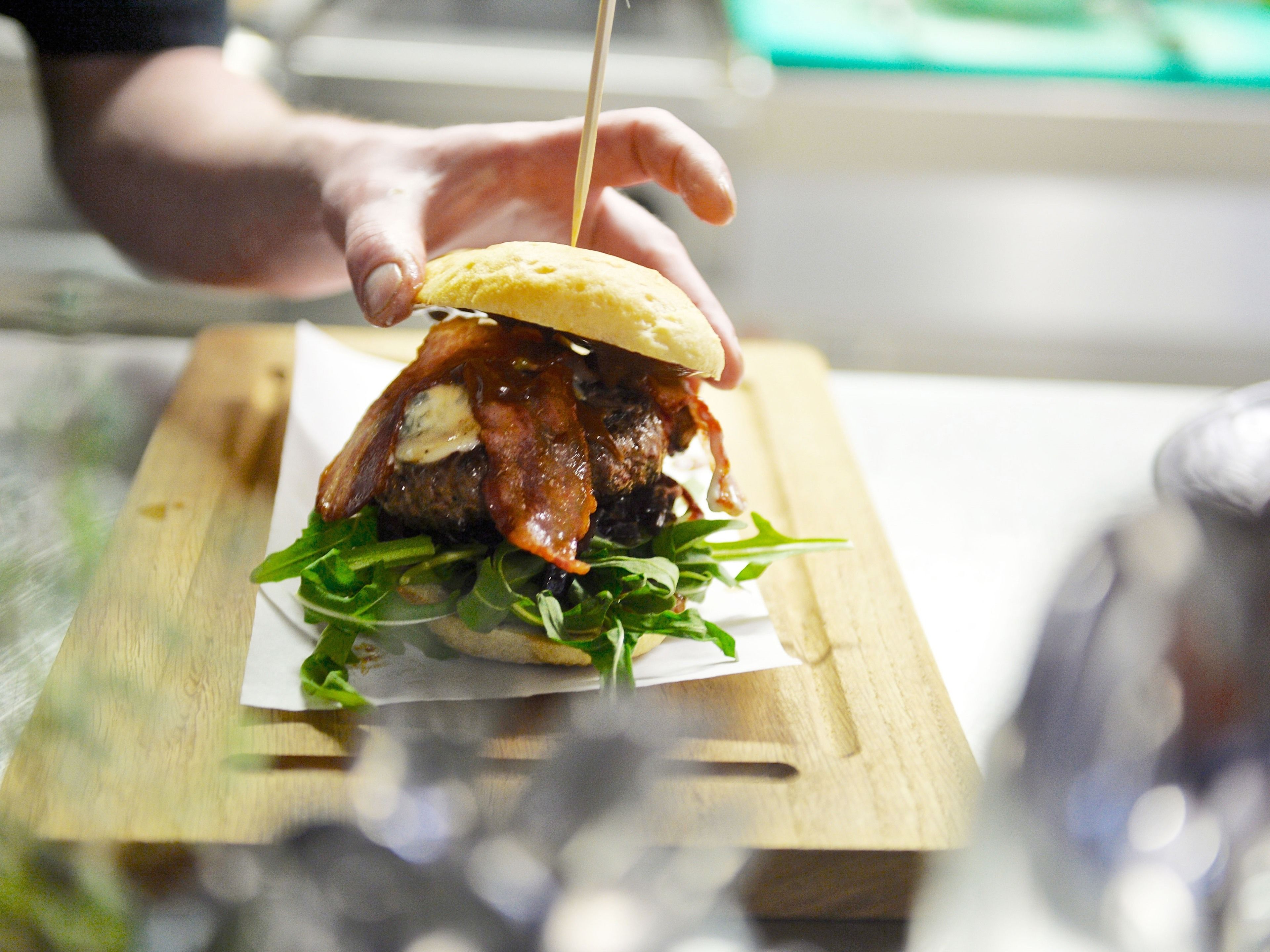 A sandwich on a wooden board.