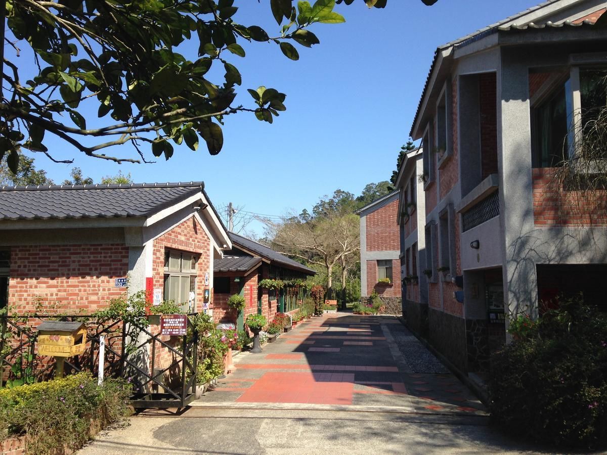 A narrow street lined with brick buildings, some with visible windows and doors.