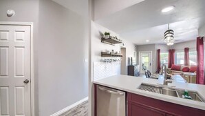 A kitchen with a dishwasher, a sink, and a countertop.