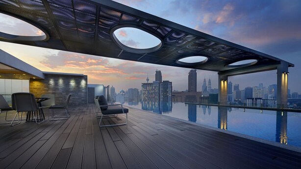A rooftop terrace with a city skyline view, wooden flooring, and modern seating. - Greystone Haus at D' Majestic Place (Kuala Lumpur)