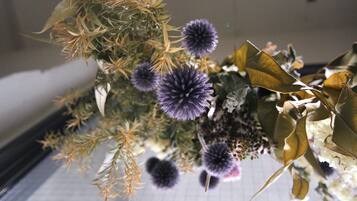 A close-up of a floral arrangement with purple flowers and green foliage.