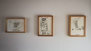 Three framed artworks on a wall.