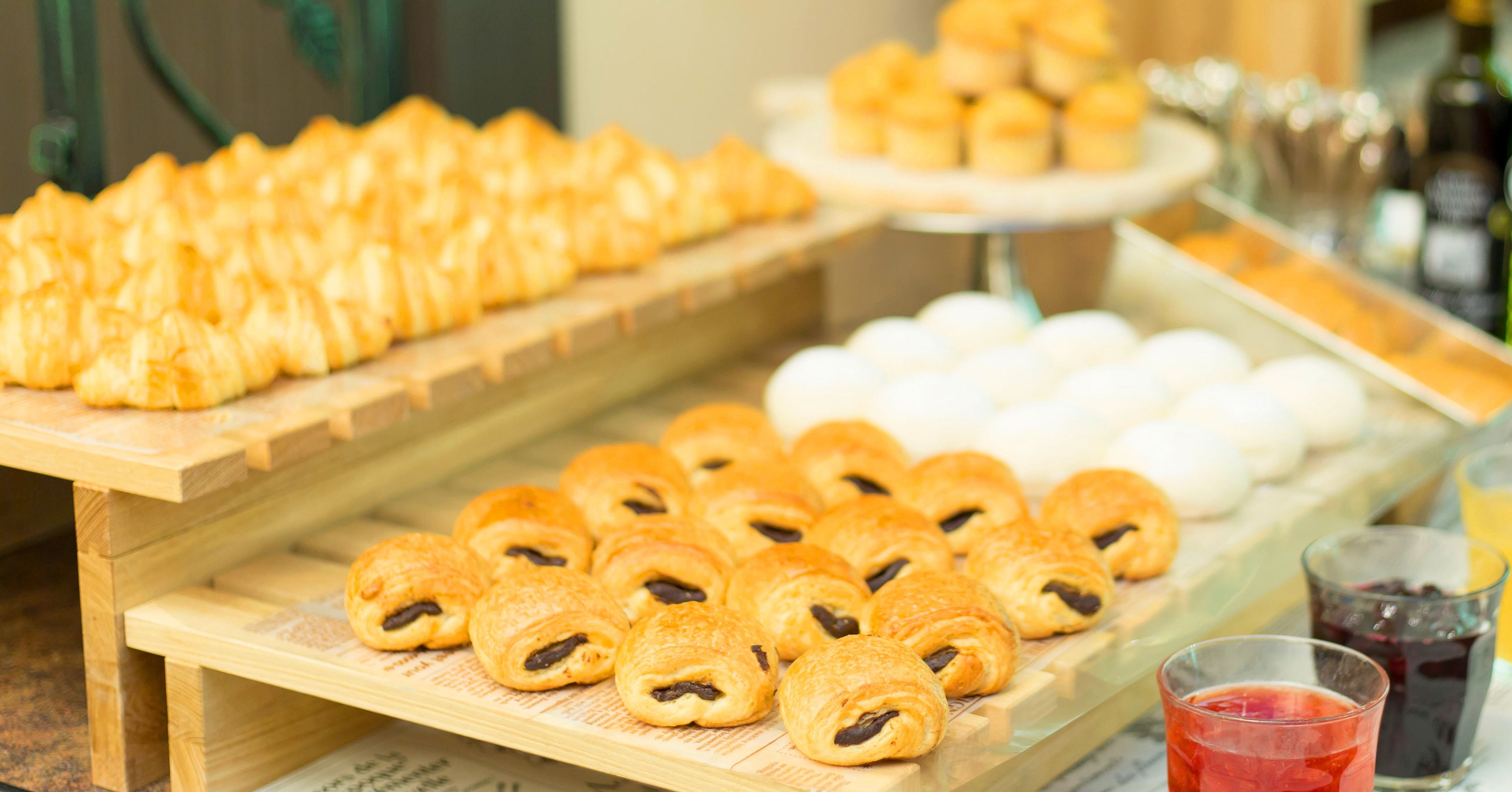 A buffet with various pastries and desserts.