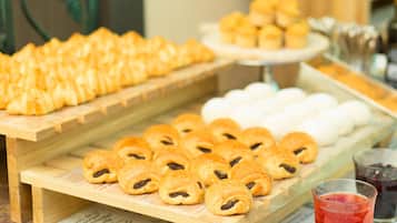 A buffet with various pastries and desserts.