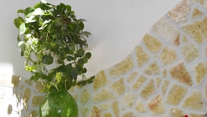 A laundry area with a washing machine, a sink, and a green plant on a table. - La Casa al Centro (Custonaci)