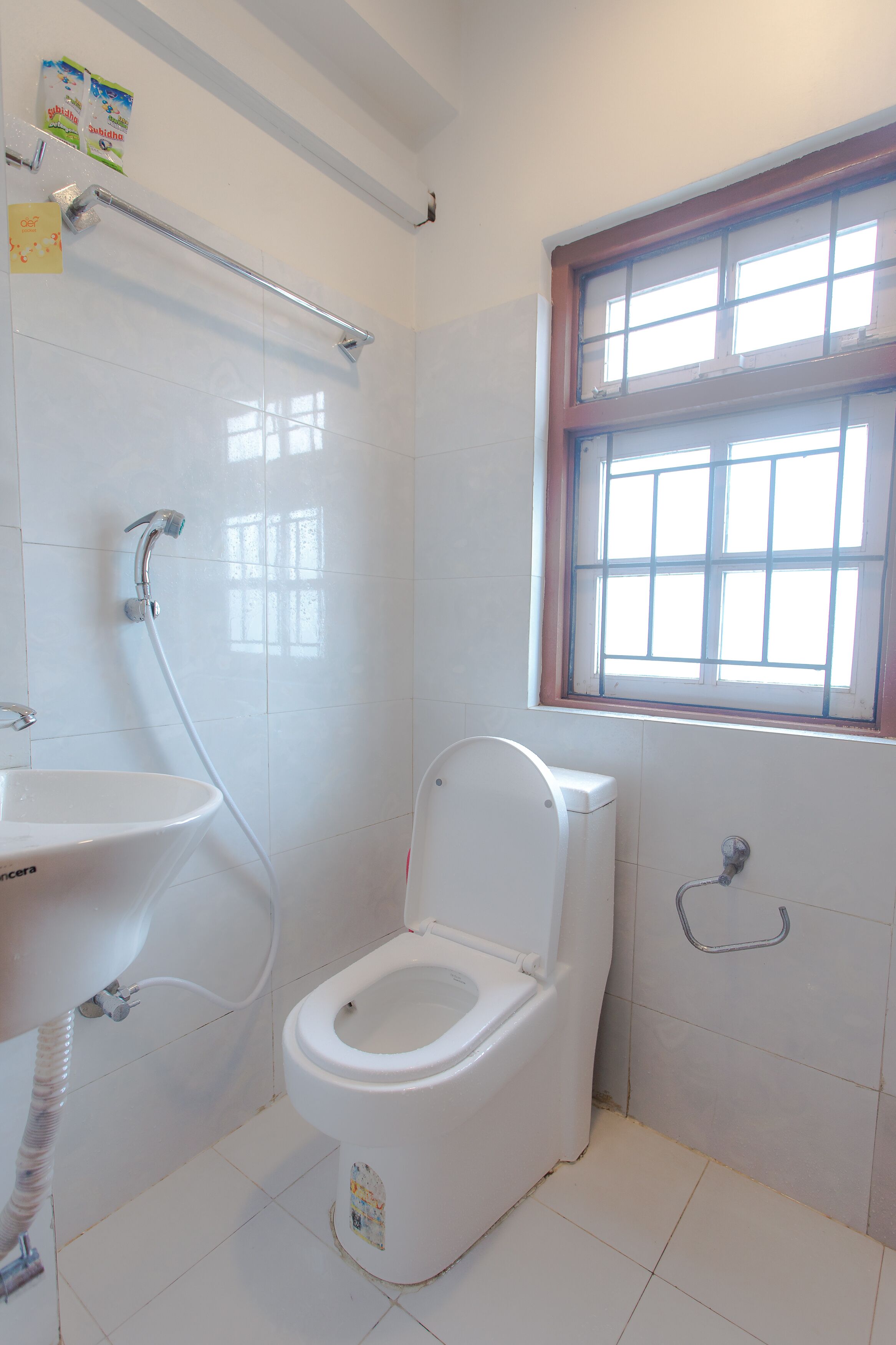 A bathroom with a toilet, a sink, and a shower.