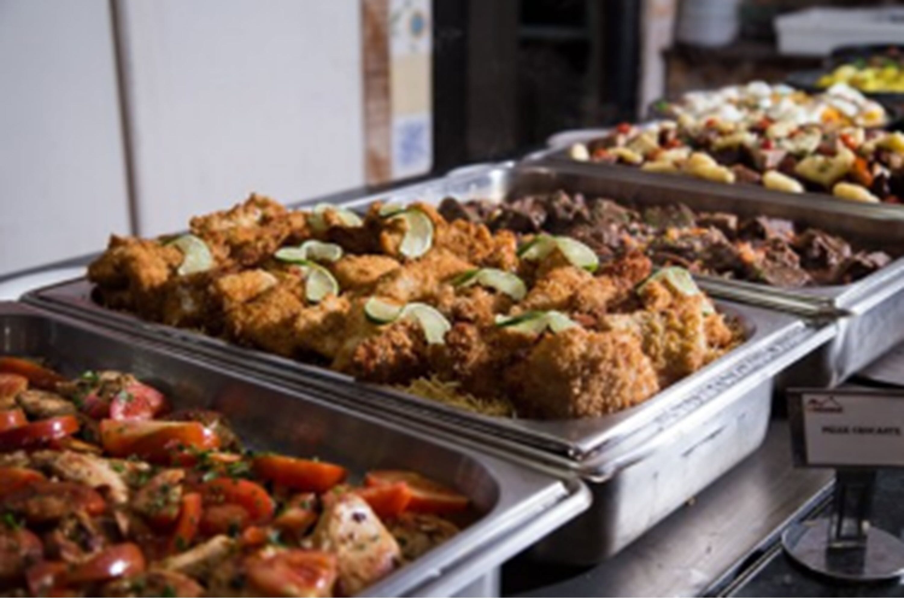 A buffet with various dishes including fried items, salads, and a section labeled "Pasta Arrabiata".