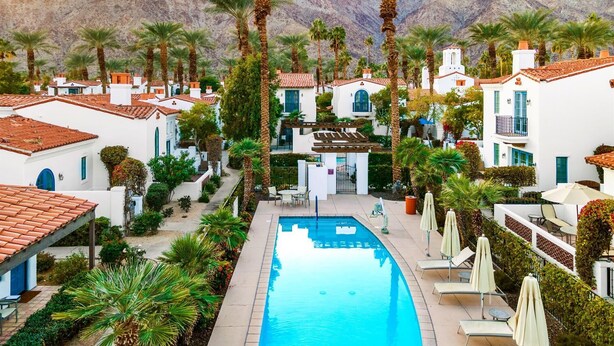 A resort with a swimming pool, palm trees, and white buildings with red roofs. - SV004 Single Story LQ Resort Studio Spa Villa (La Quinta)