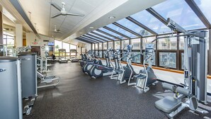 A gym with treadmills, ellipticals, and weight machines.