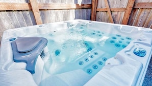 A hot tub with multiple jets, a built-in seat, and a control panel. - Antique, HOT TUB, Game Room, Theater, Dogs Ok (Bloom) (Seaview)