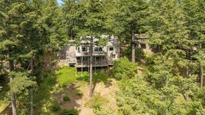 A two-story house surrounded by dense forest. - San Juan Island, Roche Harbor Overlook #196 (Roche Harbor)