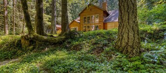 Classic riverfront home w/ great views, game room, hot tub, & modern cabin feel