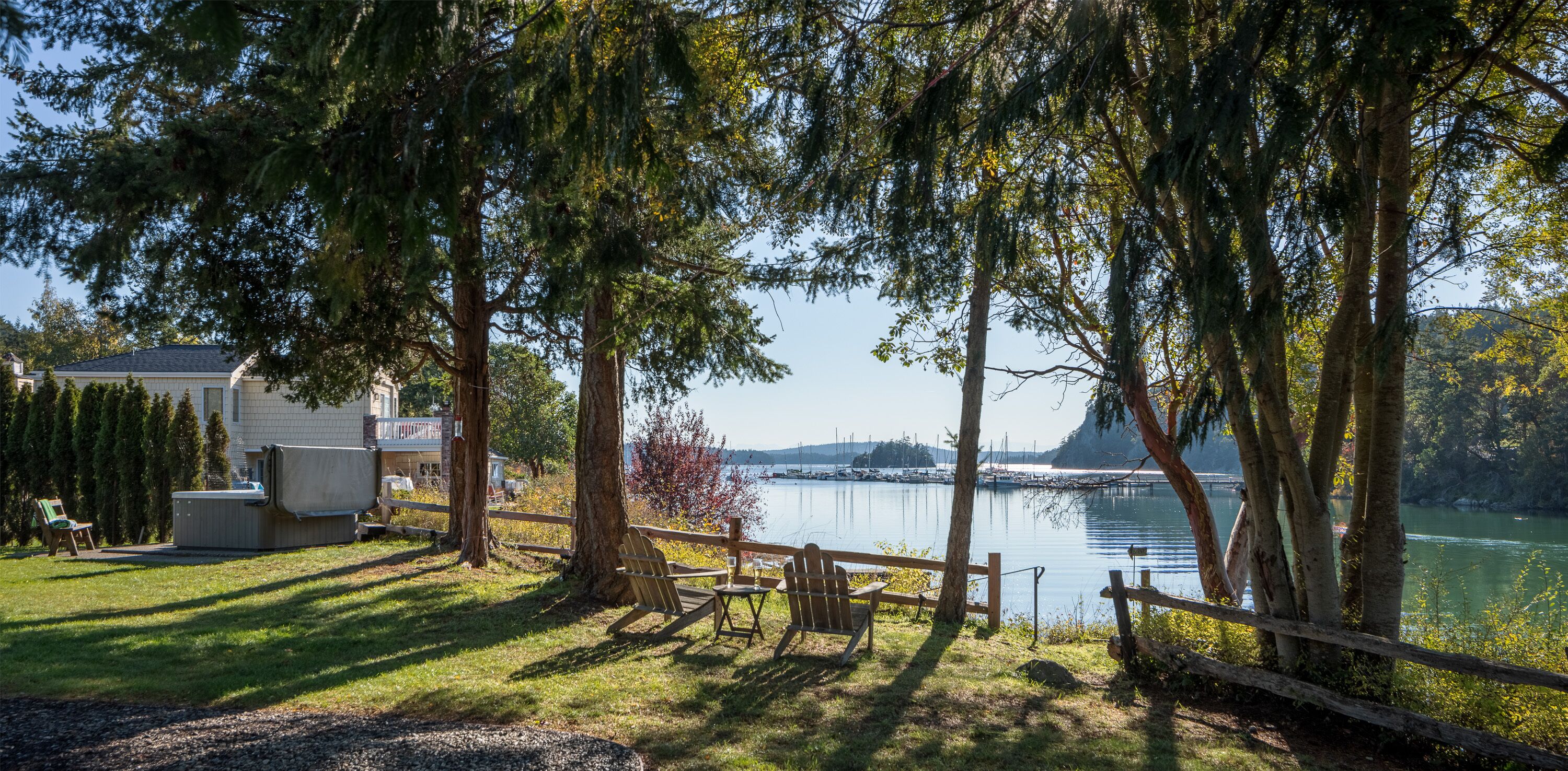 Une propriété située au bord du lac, dotée d’un bain à remous, d’une terrasse en bois et offrant une vue sur le lac et les bateaux.