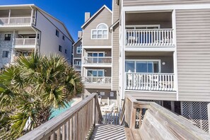 Stunning multi-story building with balconies and a pool area.