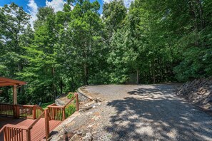 Step onto the wooden deck and take in the serene views of the lush forest.